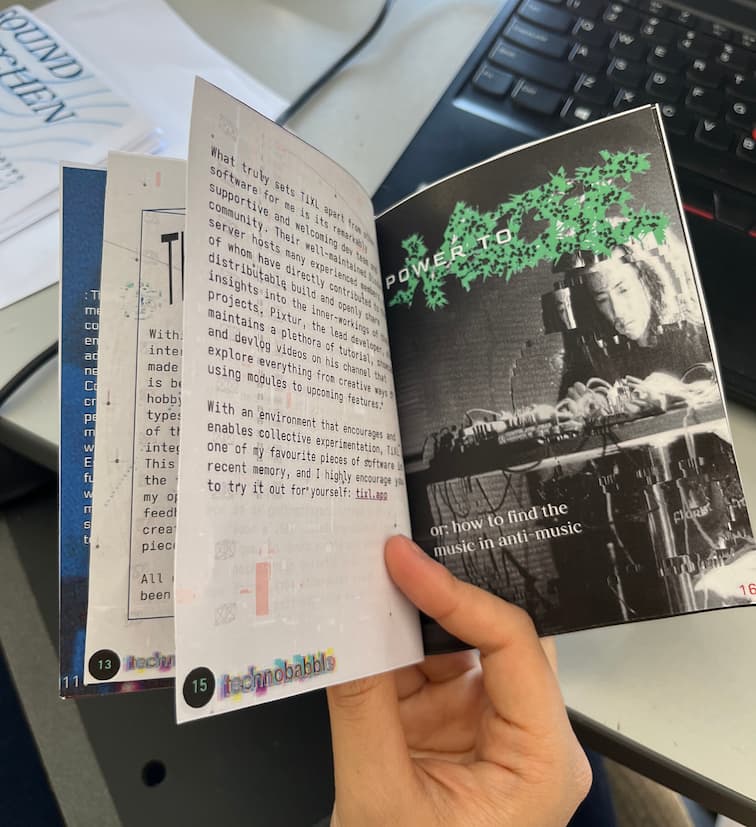 hand holding open an issue of sound kitchen zine, showing an article and collage-style layout